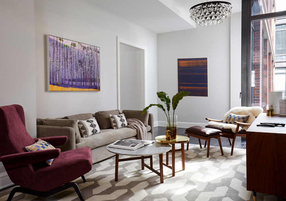 Transitional enclosed living room in New York with white walls, dark hardwood floors and brown floor.