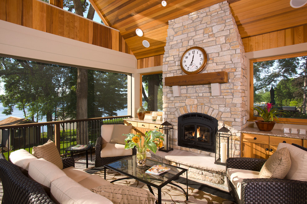Inspiration for a large traditional backyard verandah in Minneapolis with a fire feature and a roof extension.