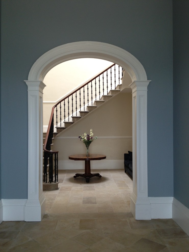 Photo of a large traditional hallway in West Midlands with blue walls and limestone floors.