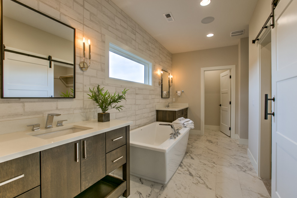Modern master bathroom in Omaha with flat-panel cabinets, dark wood cabinets, a freestanding tub, a one-piece toilet, an undermount sink, engineered quartz benchtops and an open shower.