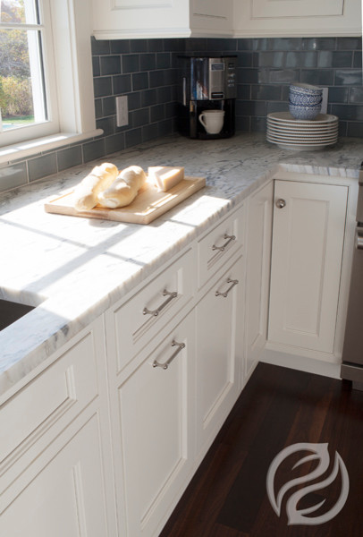Kitchen - transitional medium tone wood floor kitchen idea in Boston with beaded inset cabinets, white cabinets, an island, blue backsplash, ceramic backsplash and stainless steel appliances