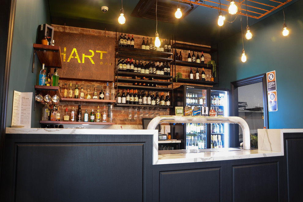 This is an example of an industrial home bar in Other.