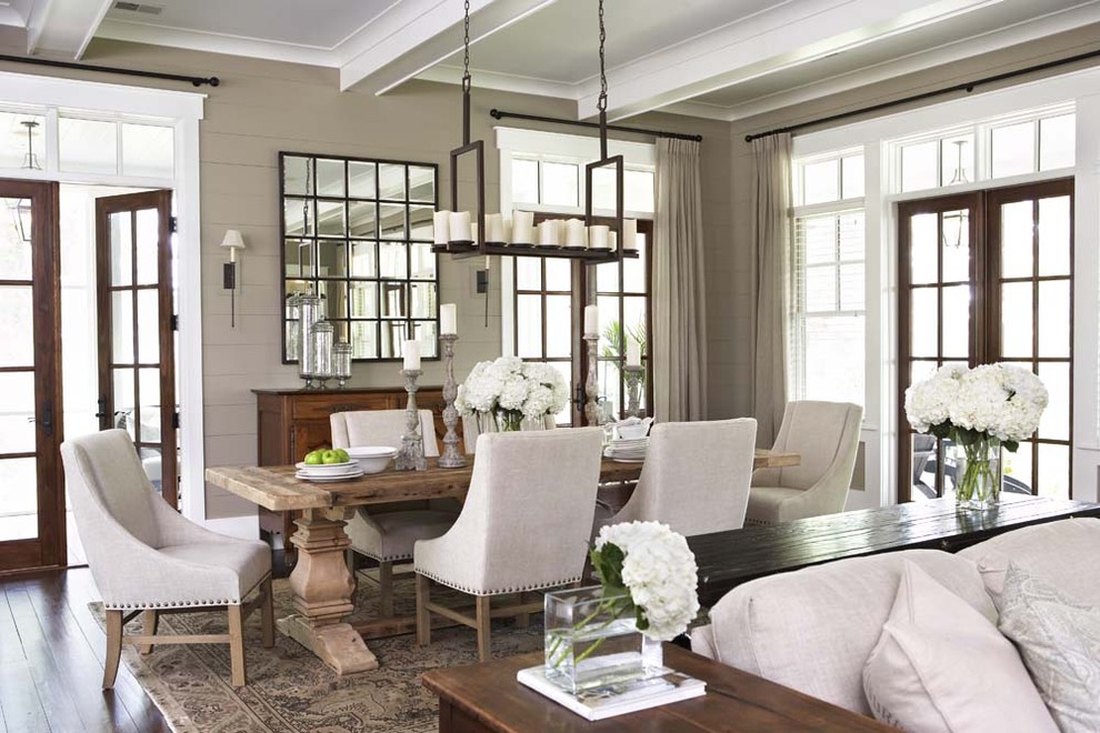 This is an example of a large traditional open plan dining in Charleston with dark hardwood floors and brown walls.