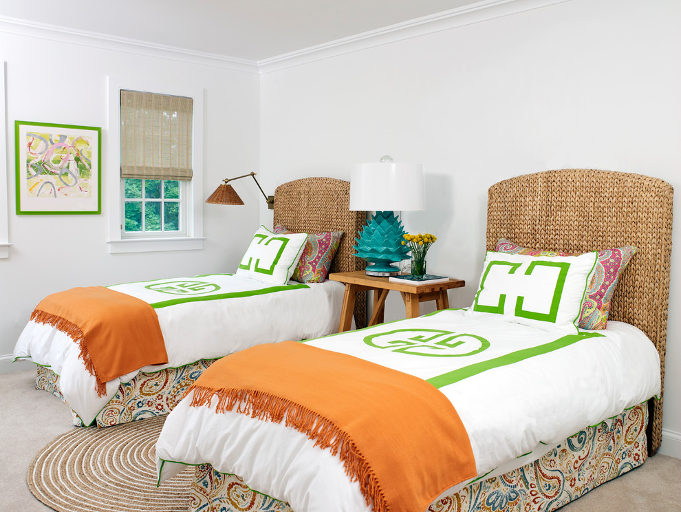 This is an example of a beach style guest bedroom in New York with white walls, carpet and beige floor.