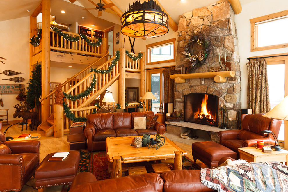 Design ideas for a large country open concept living room in Denver with a stone fireplace surround, no tv and medium hardwood floors.