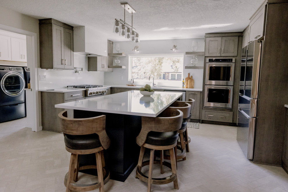 Example of a large transitional u-shaped porcelain tile and white floor kitchen design in Orlando with beaded inset cabinets, light wood cabinets, quartz countertops, white backsplash, quartz backsplash, stainless steel appliances, an island and white countertops
