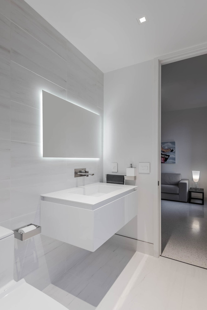 Large modern master bathroom in Other with flat-panel cabinets, white cabinets, a freestanding tub, an open shower, a one-piece toilet, white tile, white walls, ceramic floors, an integrated sink, solid surface benchtops, white floor and an open shower.