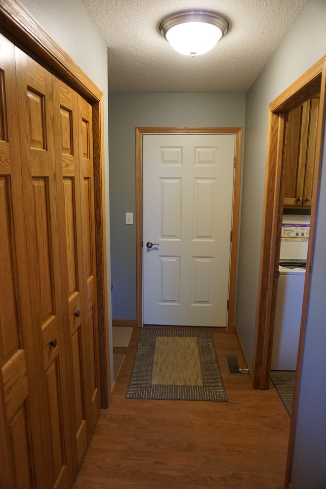 Example of a mid-sized transitional vinyl floor mudroom design with gray walls and a white front door