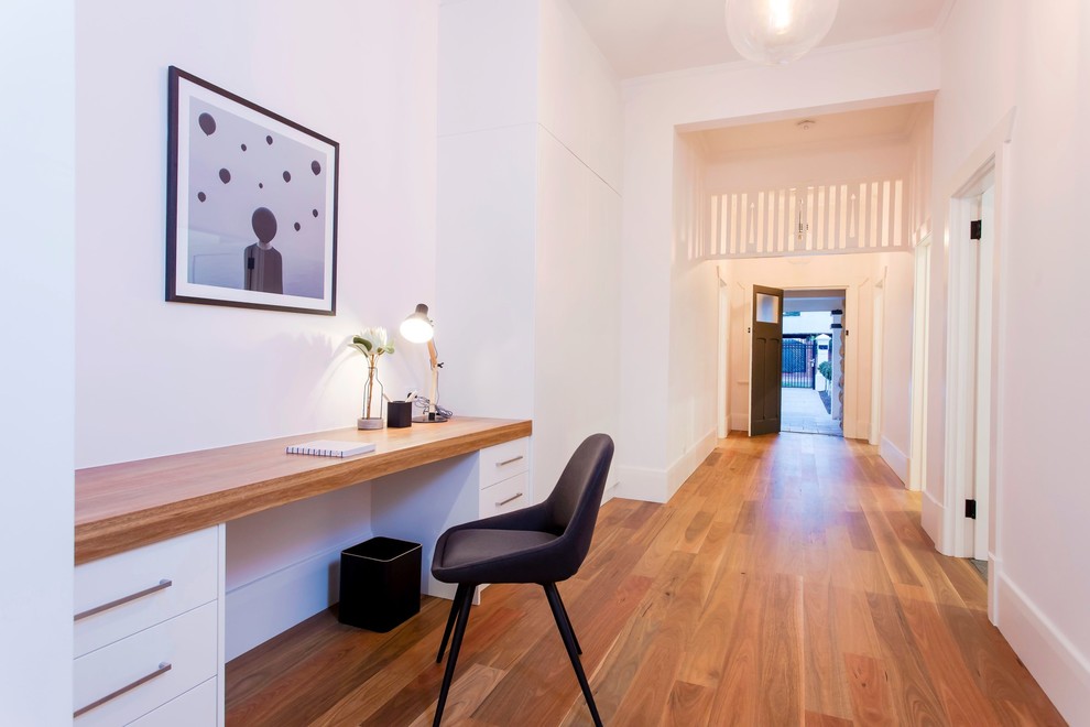 Large traditional hallway in Adelaide with white walls and medium hardwood floors.