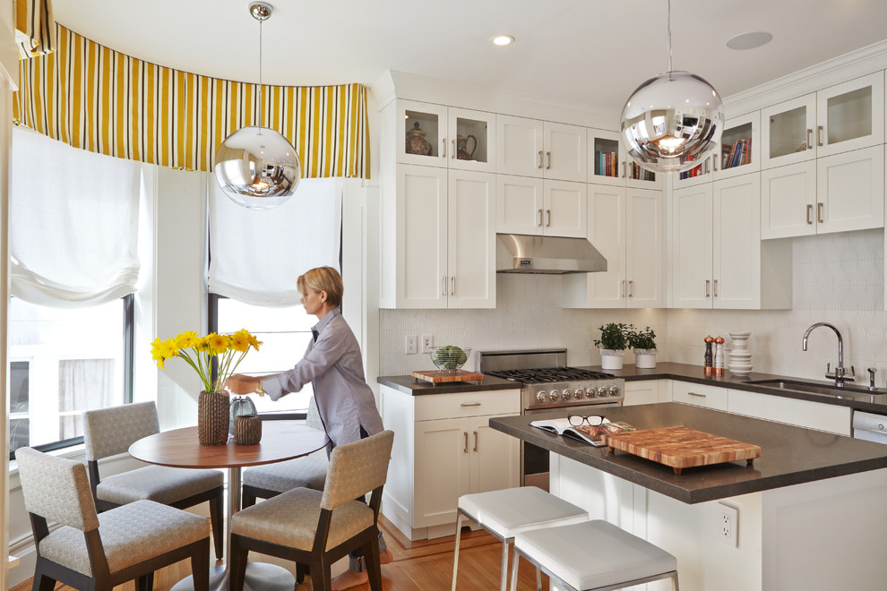 Transitional l-shaped eat-in kitchen in San Francisco with an undermount sink, shaker cabinets, white cabinets, medium hardwood floors and with island.