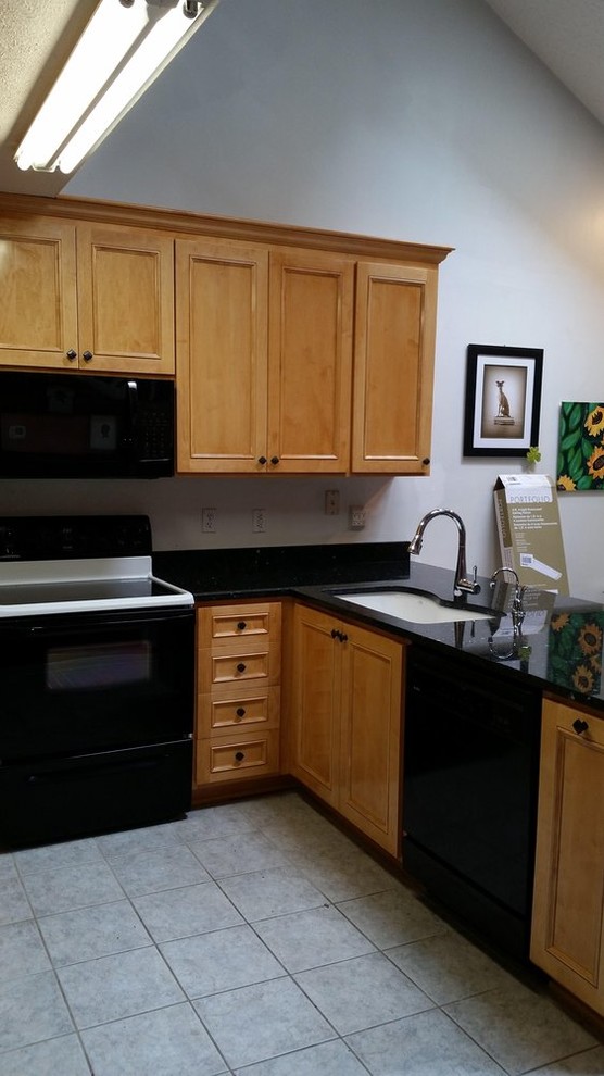 Open concept kitchen - mid-sized transitional l-shaped ceramic tile open concept kitchen idea in Richmond with an undermount sink, recessed-panel cabinets, light wood cabinets, quartzite countertops, black backsplash, stone slab backsplash, black appliances and an island
