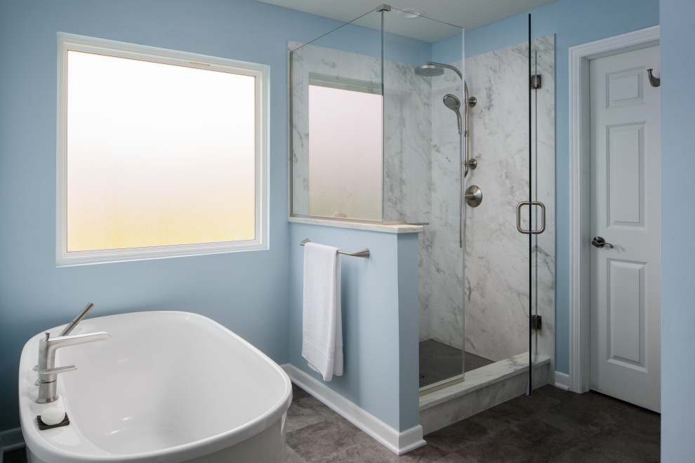 Small transitional vinyl floor and multicolored floor freestanding bathtub photo in Columbus with blue walls, an undermount sink and a hinged shower door