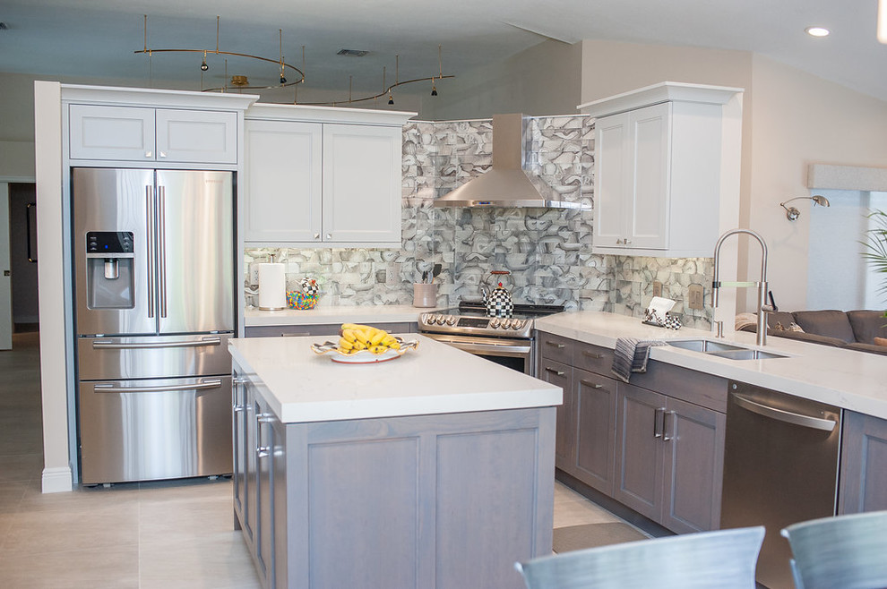 Eat-in kitchen - mid-sized transitional u-shaped porcelain tile and beige floor eat-in kitchen idea in Miami with an undermount sink, shaker cabinets, gray cabinets, quartz countertops, gray backsplash, glass tile backsplash, stainless steel appliances, an island and white countertops