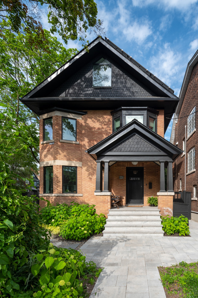 Example of a large transitional three-story brick exterior home design in Toronto with a black roof