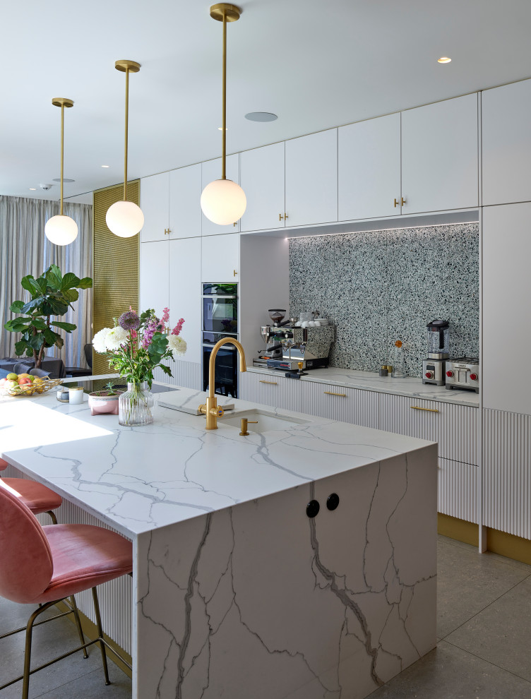 Inspiration for a contemporary kitchen in London with an undermount sink, flat-panel cabinets, white cabinets, solid surface benchtops, travertine splashback, white appliances, ceramic floors, with island, grey floor and white benchtop.