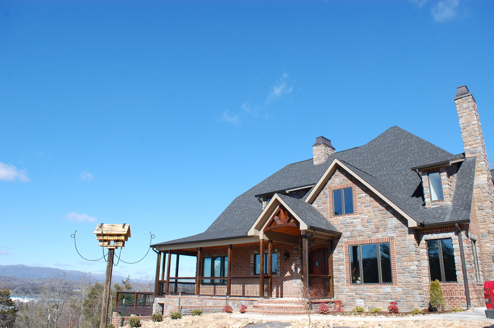 Example of a mountain style brown three-story brick exterior home design