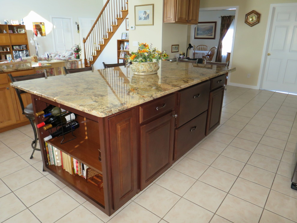 Mid-sized transitional u-shaped ceramic tile and white floor eat-in kitchen photo in Bridgeport with a double-bowl sink, raised-panel cabinets, light wood cabinets, granite countertops, white backsplash, subway tile backsplash, stainless steel appliances and an island