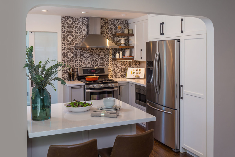 This is an example of a small eclectic u-shaped eat-in kitchen in San Francisco with a drop-in sink, shaker cabinets, grey cabinets, quartz benchtops, porcelain splashback, stainless steel appliances, dark hardwood floors, a peninsula, brown floor and white benchtop.