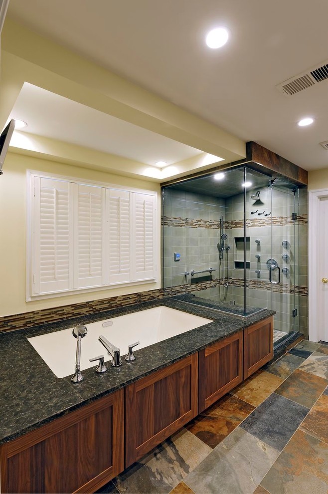 Design ideas for a transitional bathroom in DC Metro with flat-panel cabinets, medium wood cabinets, granite benchtops, an undermount tub, multi-coloured tile and porcelain tile.