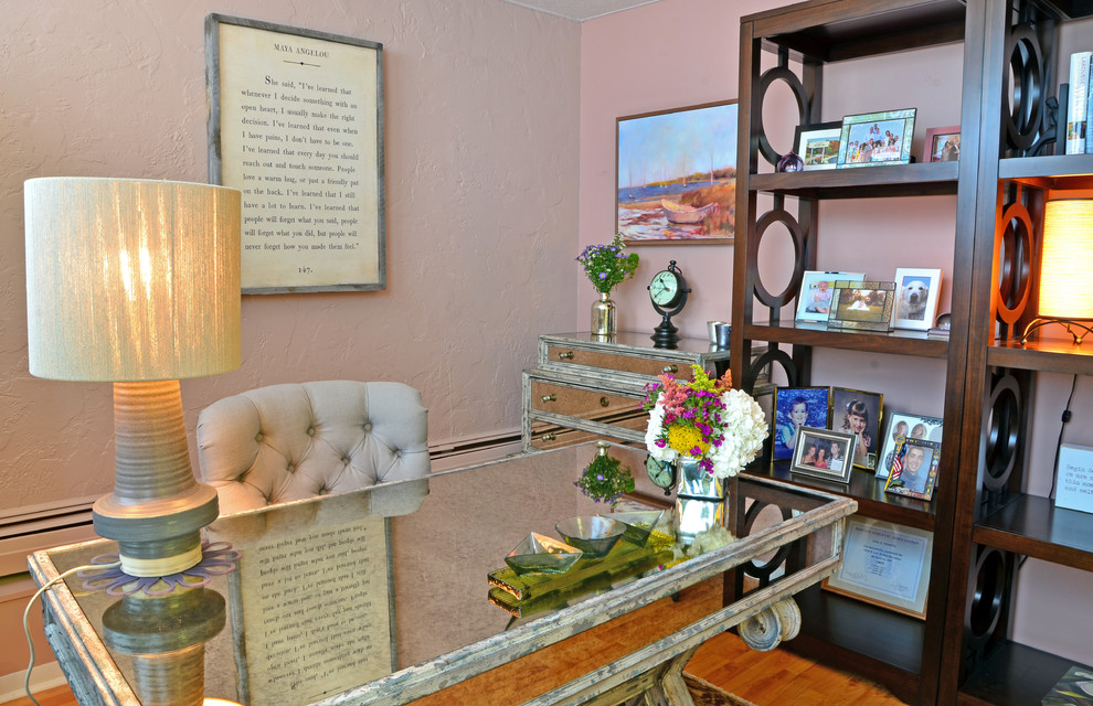 Photo of a small eclectic home office in Cleveland with pink walls, light hardwood floors and a freestanding desk.