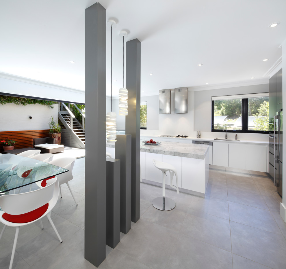 Photo of a mid-sized contemporary single-wall eat-in kitchen in Sydney with an undermount sink, flat-panel cabinets, white cabinets, granite benchtops, white splashback, glass sheet splashback, stainless steel appliances and with island.