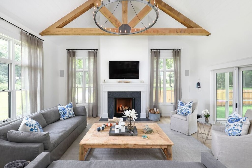 Modern Farmhouse - Inspiration for a cottage light wood floor family room remodel in Chicago with white walls, a standard fireplace and a wall-mounted tv