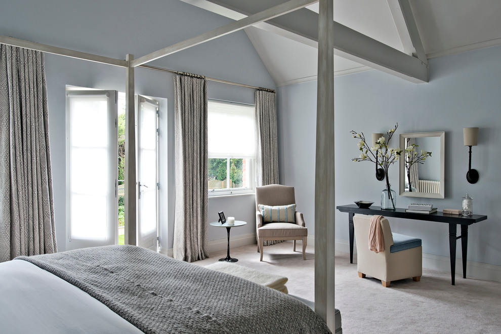 Photo of a large contemporary bedroom in Gloucestershire with blue walls and carpet.