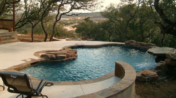 Design ideas for a contemporary backyard custom-shaped pool in Austin.