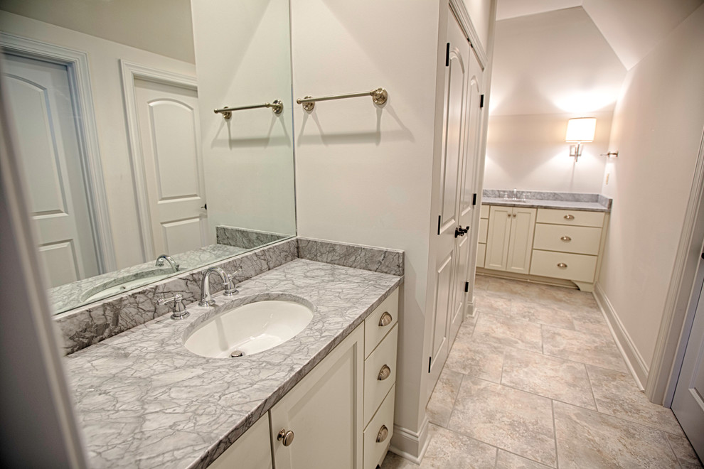 Design ideas for a mid-sized transitional master bathroom in Birmingham with an undermount sink, recessed-panel cabinets, white cabinets, marble benchtops, a corner shower, gray tile, porcelain tile, grey walls and ceramic floors.
