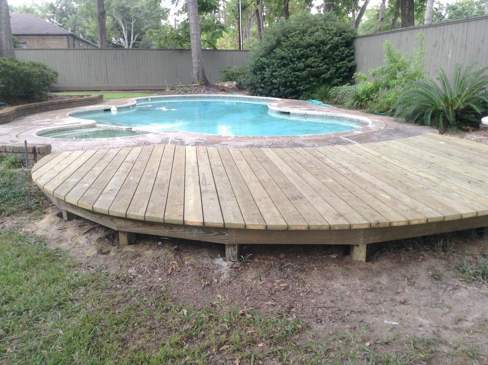 Photo of a mid-sized country backyard custom-shaped aboveground pool in Houston with a hot tub and decking.