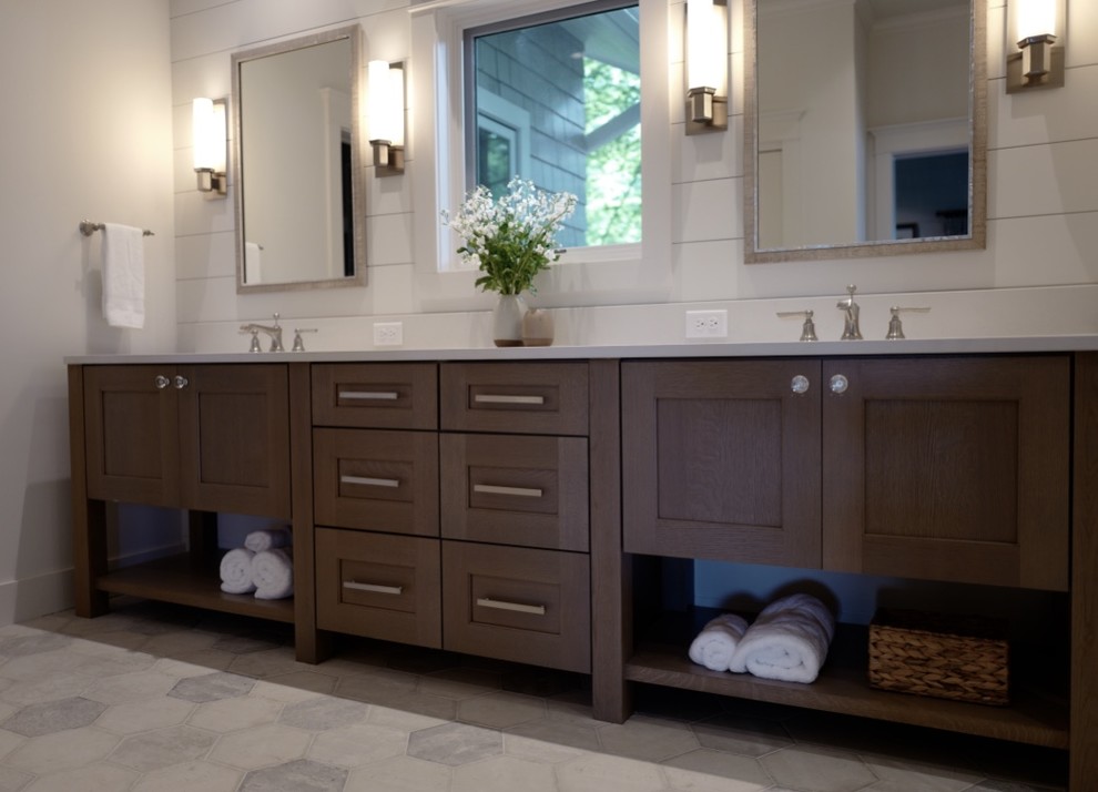 This is an example of a large transitional master bathroom in Other with furniture-like cabinets, medium wood cabinets, a double shower, white tile, white walls, porcelain floors, an undermount sink, engineered quartz benchtops, grey floor and a hinged shower door.