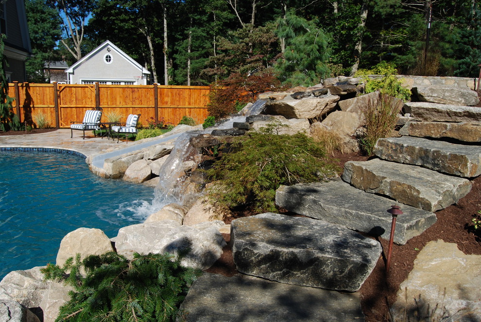Water slide - mid-sized rustic backyard stone and kidney-shaped natural water slide idea in Boston
