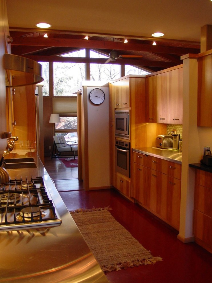 This is an example of a mid-sized contemporary l-shaped separate kitchen in Other with an integrated sink, flat-panel cabinets, medium wood cabinets, stainless steel benchtops, green splashback, mosaic tile splashback, stainless steel appliances, dark hardwood floors, no island and brown floor.