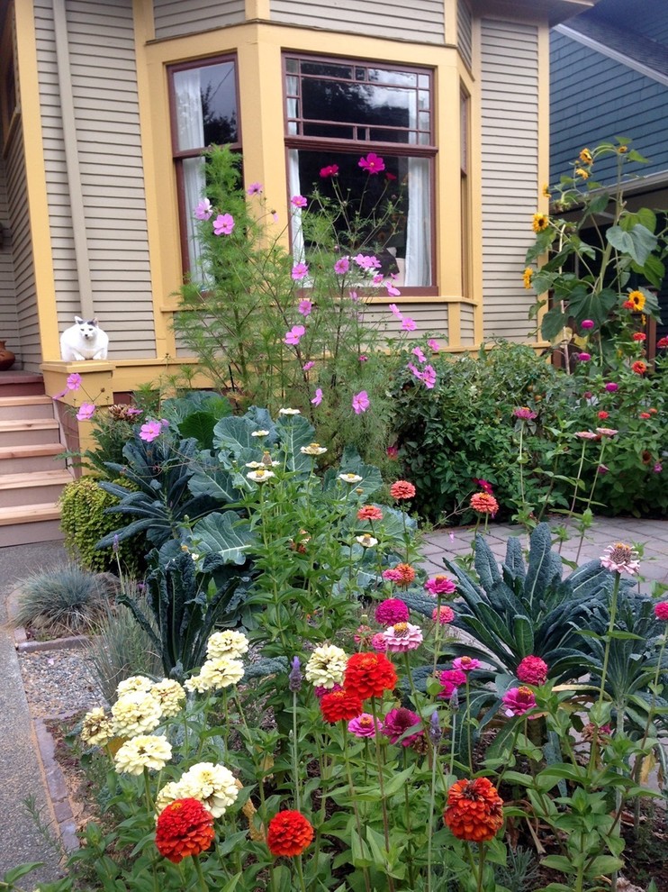 Mid-sized eclectic front yard patio in Seattle with a vegetable garden, concrete slab and no cover.