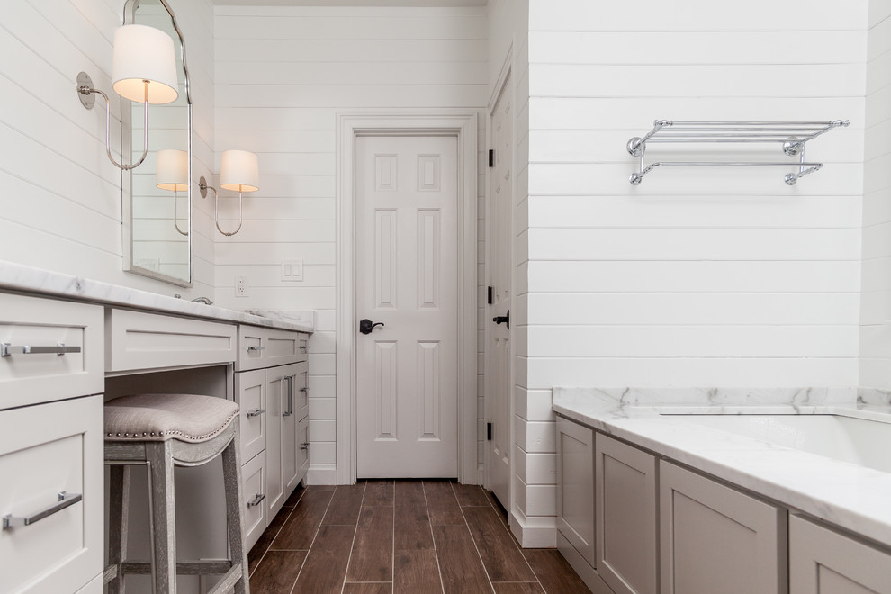 Design ideas for a mid-sized country master bathroom in Atlanta with shaker cabinets, grey cabinets, an undermount tub, an open shower, a two-piece toilet, white tile, ceramic tile, white walls, porcelain floors, an undermount sink, marble benchtops, brown floor, a hinged shower door and white benchtops.