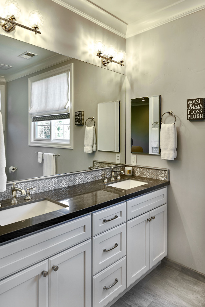 Photo of a large traditional family bathroom in San Francisco with recessed-panel cabinets, white cabinets, an alcove bath, a two-piece toilet, grey tiles, ceramic tiles, grey walls, porcelain flooring, a submerged sink, quartz worktops, grey floors, a hinged door, grey worktops, a wall niche, double sinks, a built in vanity unit and a shower/bath combination.