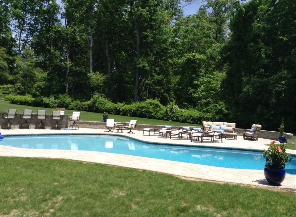 Large backyard stone and custom-shaped natural pool fountain photo in Baltimore
