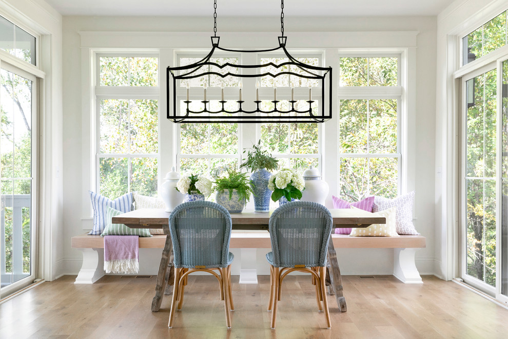 Inspiration for a transitional dining room in Minneapolis with white walls, light hardwood floors and beige floor.