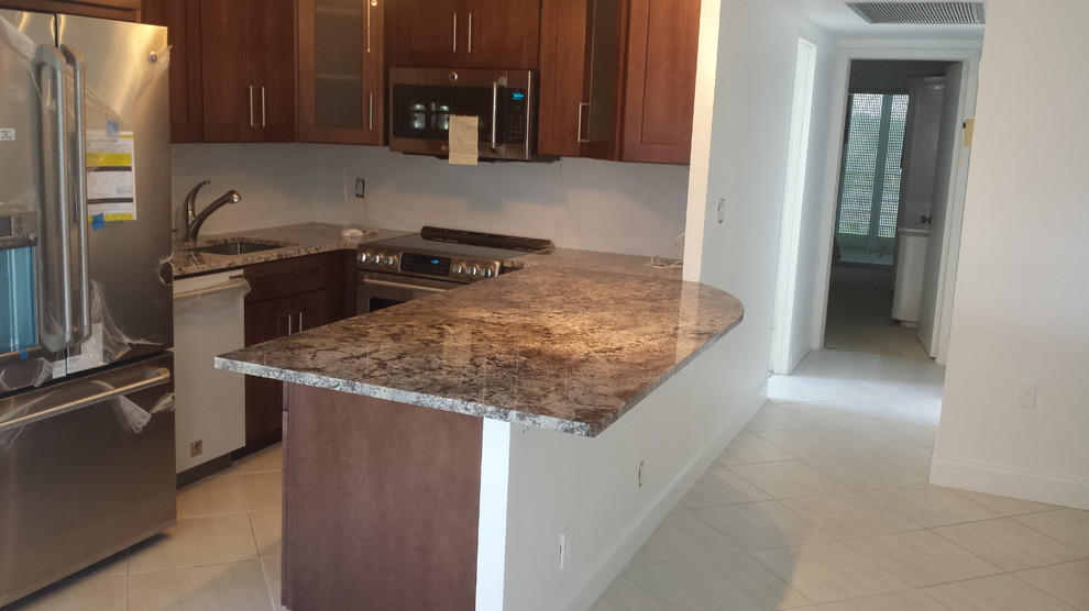 Example of a small transitional u-shaped ceramic tile eat-in kitchen design in Miami with a single-bowl sink, shaker cabinets, dark wood cabinets, stainless steel appliances and a peninsula