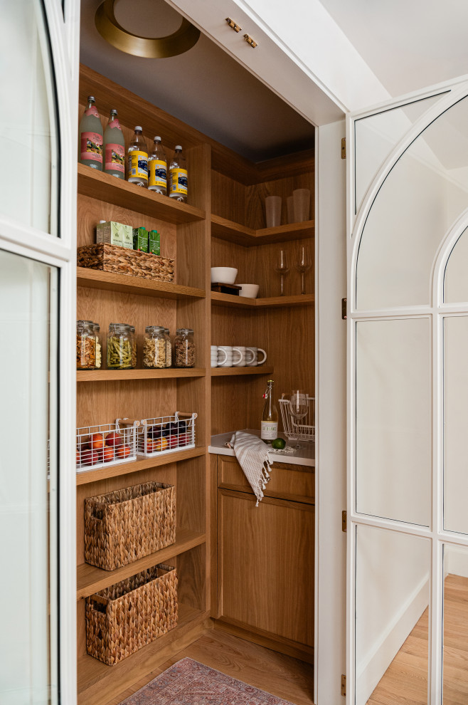 Example of a mid-sized transitional l-shaped light wood floor eat-in kitchen design in Chicago with an undermount sink, shaker cabinets, light wood cabinets, marble countertops, white backsplash, marble backsplash, paneled appliances, an island and white countertops