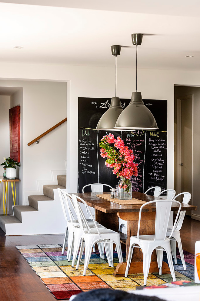 This is an example of a contemporary open plan dining in Perth with white walls and dark hardwood floors.