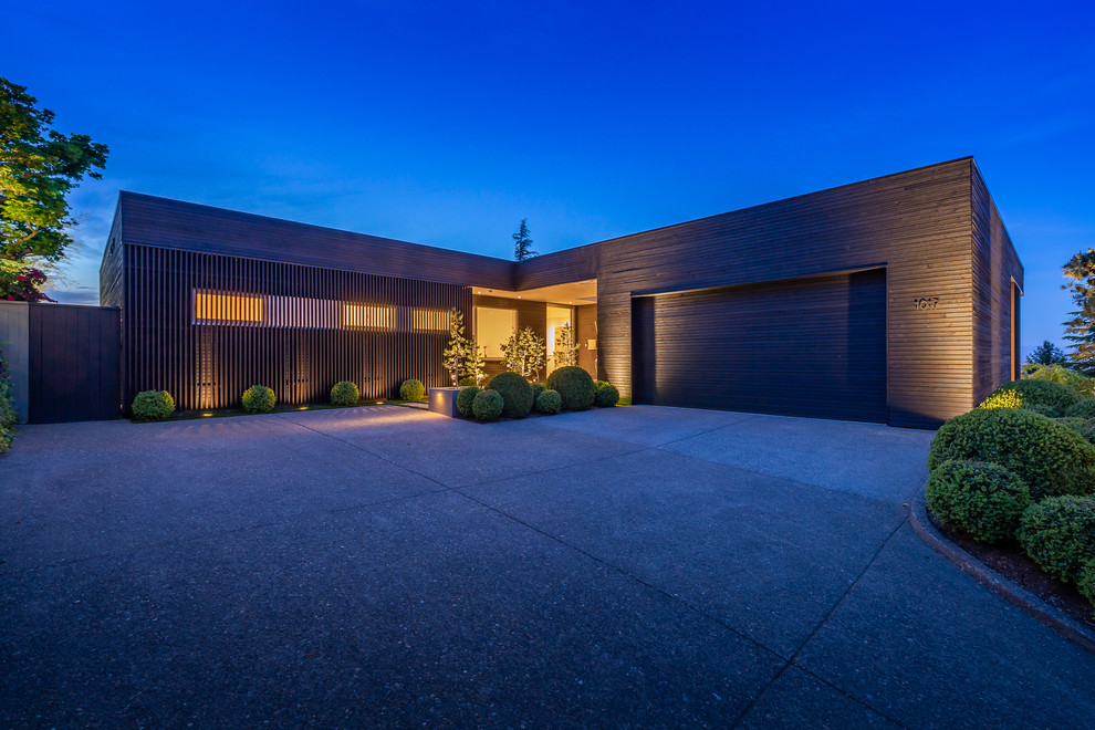 Contemporary one-storey house exterior in Portland with wood siding and a flat roof.