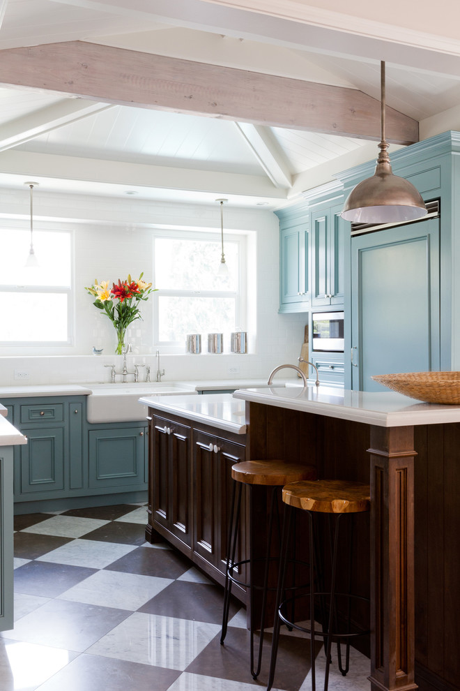 Design ideas for a mid-sized traditional u-shaped kitchen in Los Angeles with blue cabinets and with island.