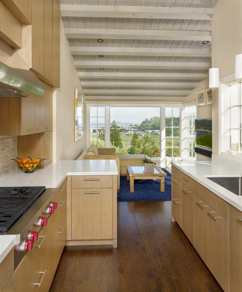 This is an example of a contemporary kitchen in San Francisco with flat-panel cabinets, matchstick tile splashback, stainless steel appliances, an undermount sink, beige splashback and light wood cabinets.