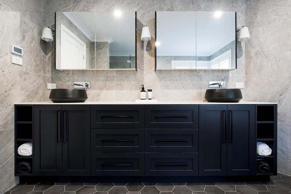 This is an example of a large master bathroom in Sydney with shaker cabinets, black cabinets, a freestanding tub, a corner shower, black and white tile, ceramic tile, white walls, ceramic floors, a vessel sink, tile benchtops, brown floor, a hinged shower door and multi-coloured benchtops.