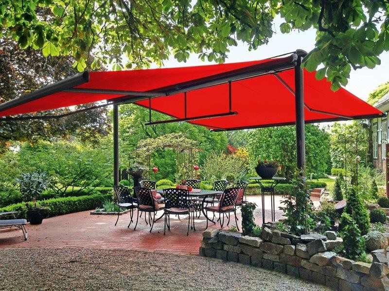 Inspiration for a mid-sized contemporary backyard patio in Other with brick pavers and an awning.