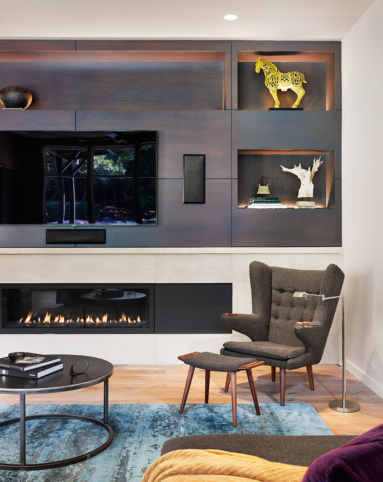 Photo of a mid-sized contemporary open concept living room in Austin with grey walls, light hardwood floors, a ribbon fireplace, a metal fireplace surround, a built-in media wall and beige floor.