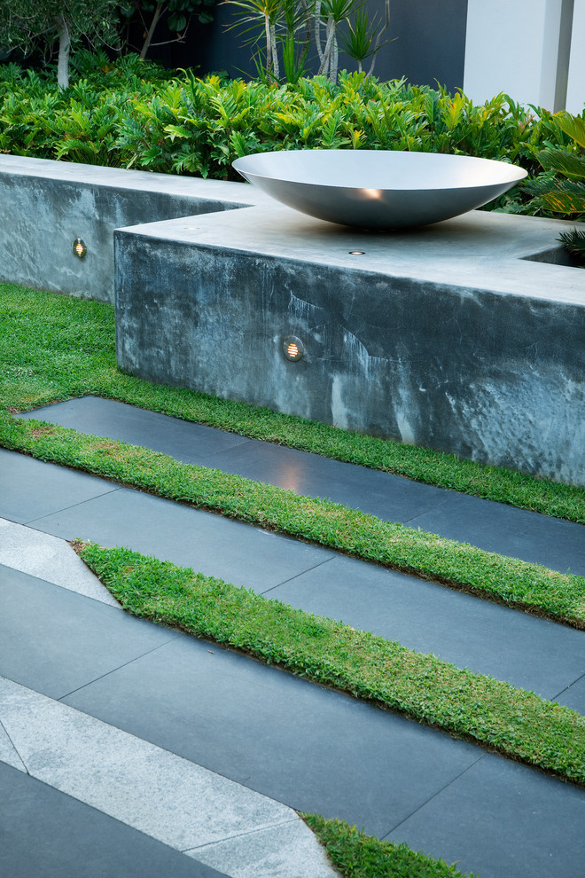 This is an example of a small contemporary courtyard patio in Perth with natural stone pavers.