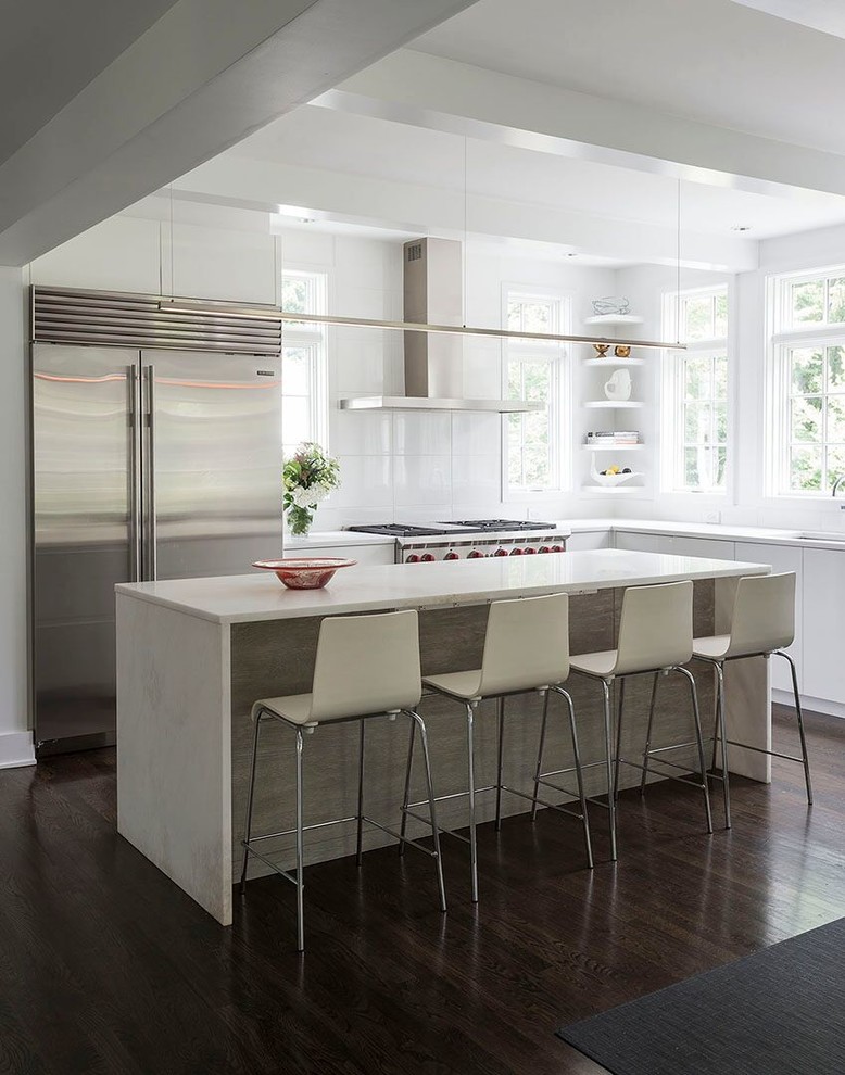 Inspiration for a contemporary l-shaped kitchen in Calgary with an undermount sink, flat-panel cabinets, white cabinets, white splashback, stainless steel appliances, dark hardwood floors and with island.