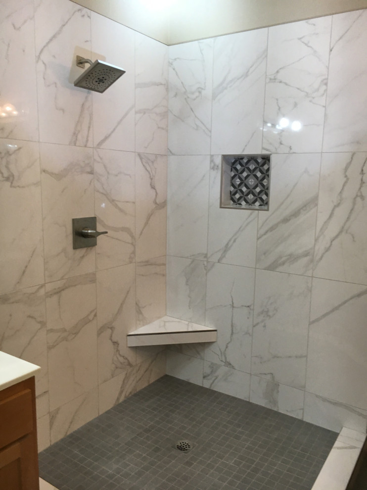 Photo of a medium sized contemporary ensuite bathroom in San Francisco with shaker cabinets, white cabinets, a corner shower, a one-piece toilet, white tiles, porcelain tiles, white walls, porcelain flooring, a submerged sink, engineered stone worktops, grey floors, a hinged door, grey worktops, a wall niche, double sinks and a built in vanity unit.